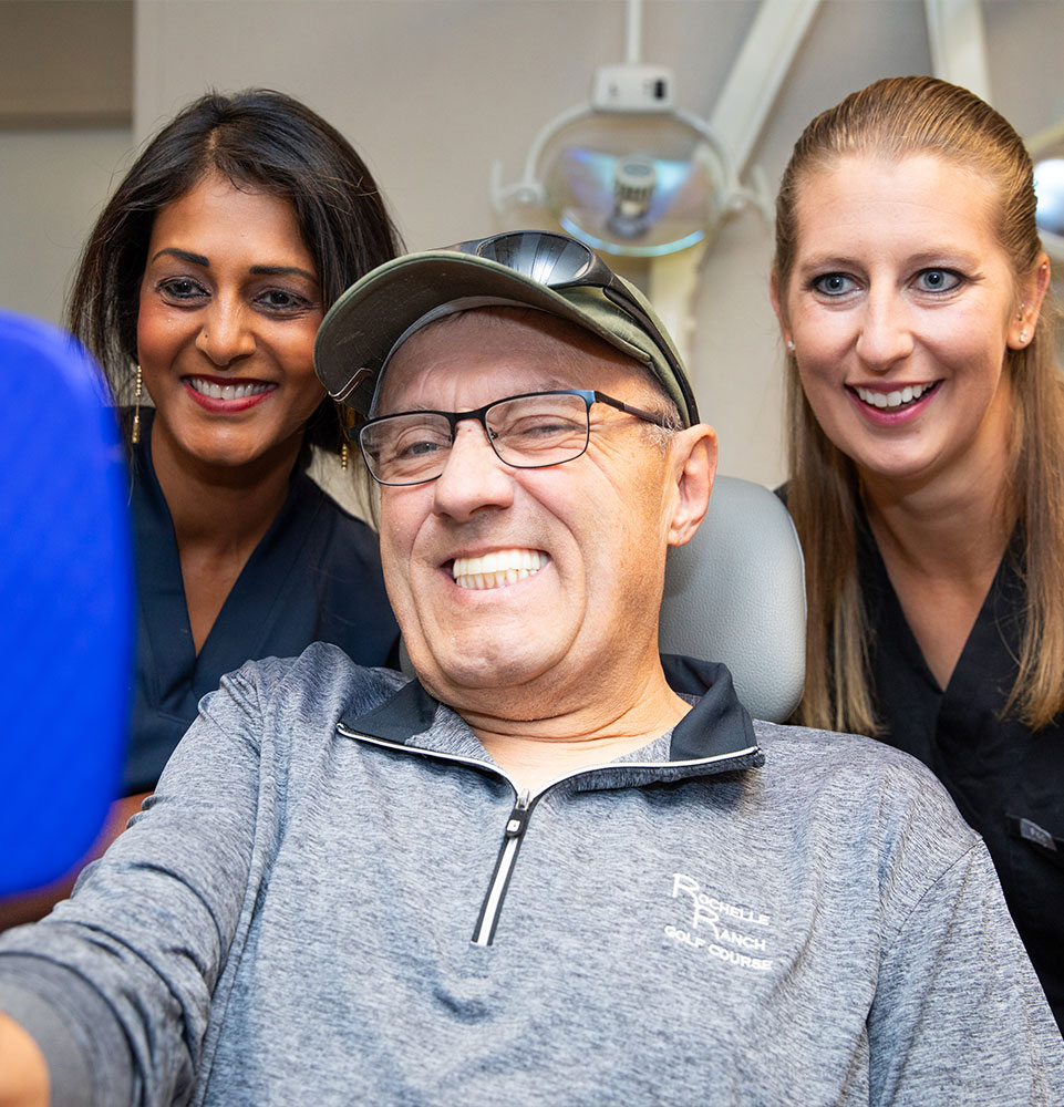 Patient and doctor looking into mirror