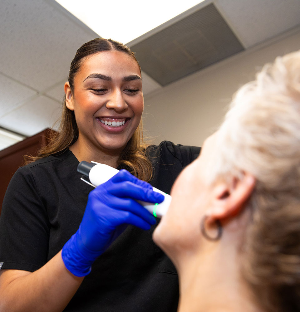 team member taking a 3d scan of Patients teeth