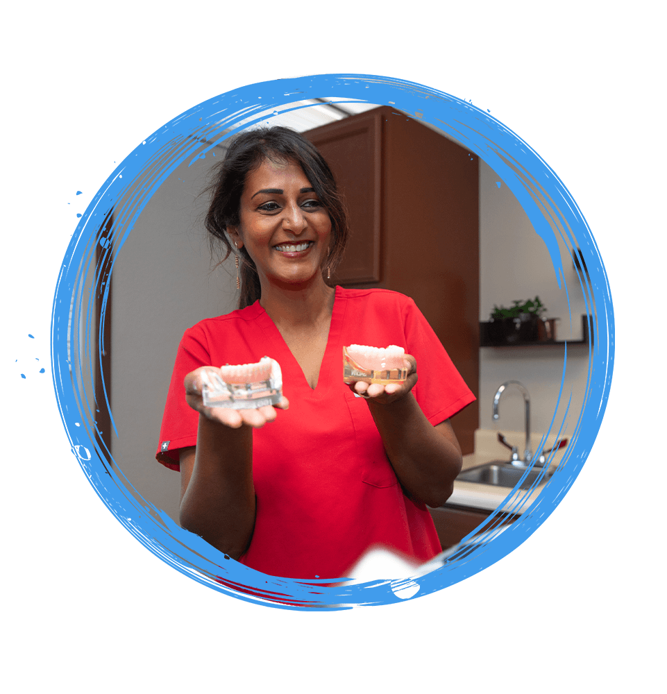 Doctor holding a model of full arch dental implants