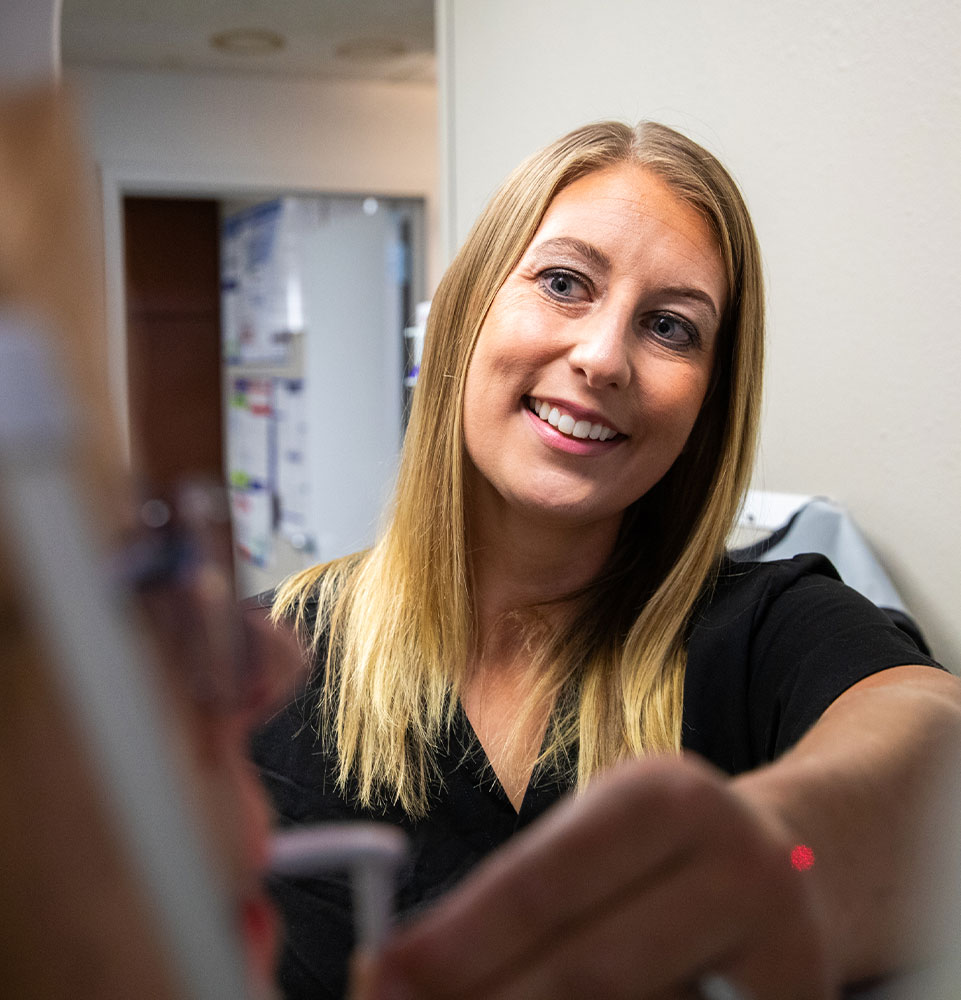 Team member taking a x-ray of Patient teeth